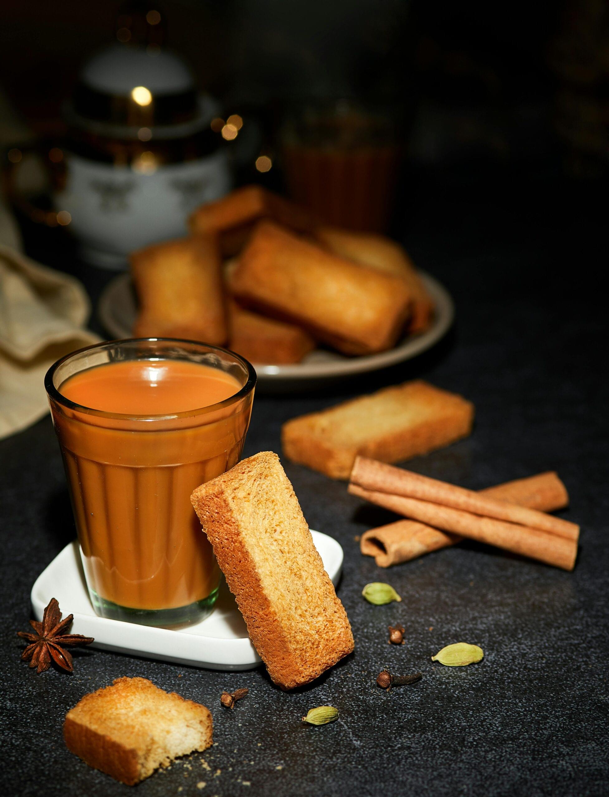 Warm masala tea with spiced biscuits and aromatic herbs for a flavorful Indian tea experience.